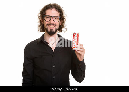 BANGKOK, THAILAND - DECEMBER 19, 2016 - Man holding Coke can made by The Coca-Cola Company illustrative editorial shot without editing against white background with studio strobes Stock Photo