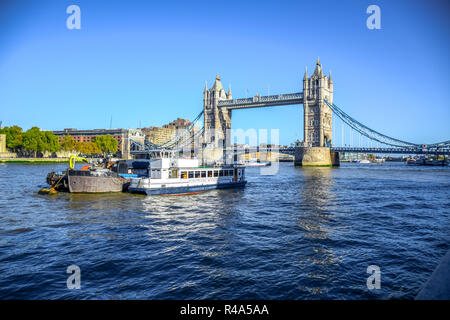 Tower Bridge, famous iconic symbol of London,  crosses the River Thames close to the Tower of London located in London, England, United Kingdom Stock Photo