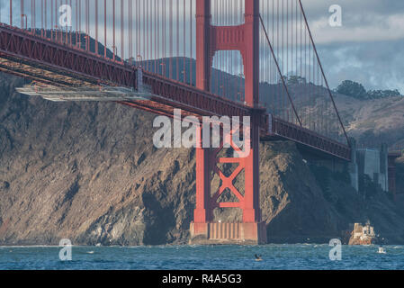 The golden gate bridge as seen from the Bay, scaffolding is visible underneath as bridge maintenance is underway. Stock Photo