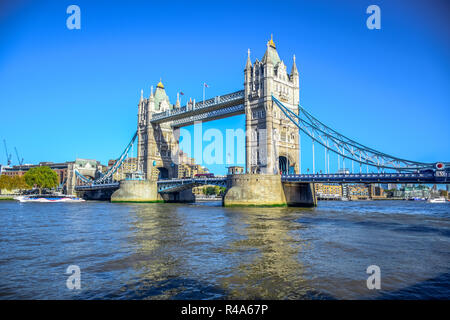 Tower Bridge, famous iconic symbol of London,  crosses the River Thames close to the Tower of London located in London, England, United Kingdom Stock Photo