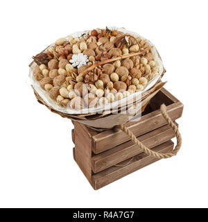 Decorative bouquet consisting of different nuts is in the wooden box on a white background Stock Photo