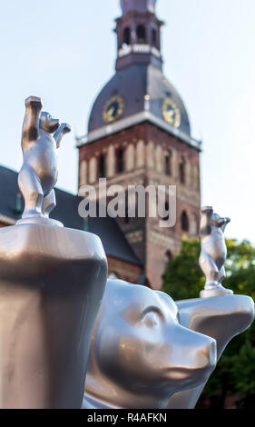 'Respect for life' bear at United Buddy Bears international art exhibition (Artists: A. Oetker, A. Haufe) with Riga Cathedral tower in background. Stock Photo