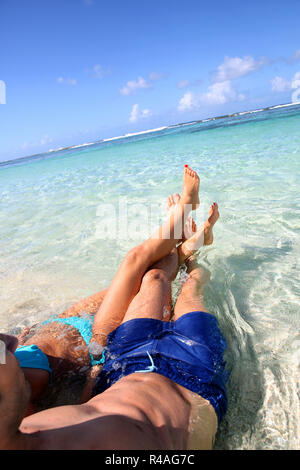 Couple relaxing in Carribean sea water Stock Photo