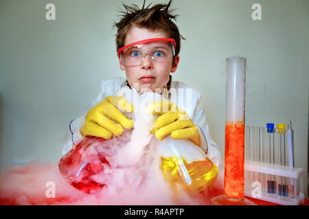 Crazy scientist performing experiments in lab Stock Photo