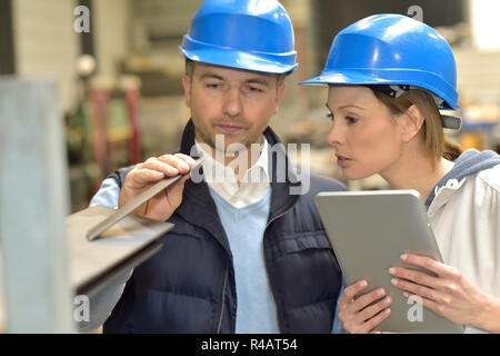 Supplier with engineer checking on production in factory Stock Photo