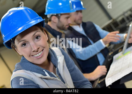 Cheerful woman industrial engineer at work Stock Photo