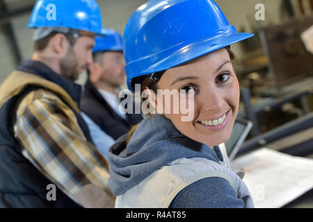 Cheerful woman industrial engineer at work Stock Photo