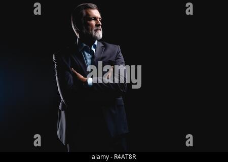 Handsome mature business man isolated on black background Stock Photo