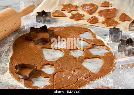 Raw gingerbread dough rolled out on table Stock Photo