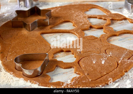 Raw gingerbread dough rolled out on table Stock Photo