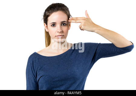 Young woman simulates to shoot himself in the head with one hand Stock Photo