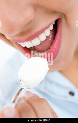 young woman eating yogurt Stock Photo