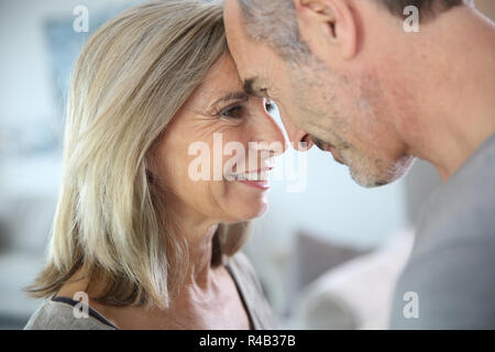 Loving senior couple looking at each other's eyes Stock Photo