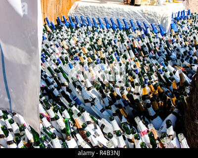 Pile of beer bottle on the beach of Santorini, Greece Stock Photo