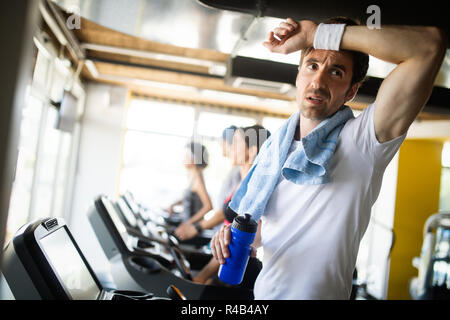 Handsome sporty man resting, having break doing exercise Stock Photo