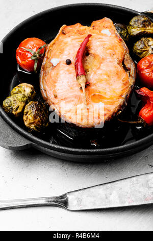 Grilled salmon with vegetables in a pan.Fish steak with vegetable garnish.Fish food Stock Photo