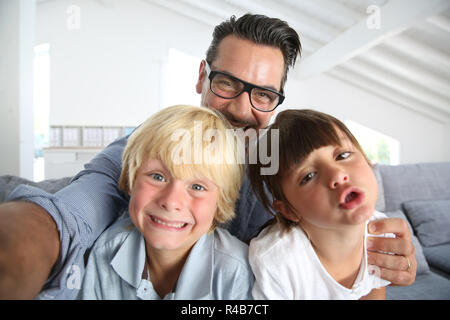Dad with kids taking picture of themselves Stock Photo - Alamy