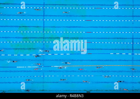 Aerial view of swimming pool with marked lanes and swimmers Stock Photo