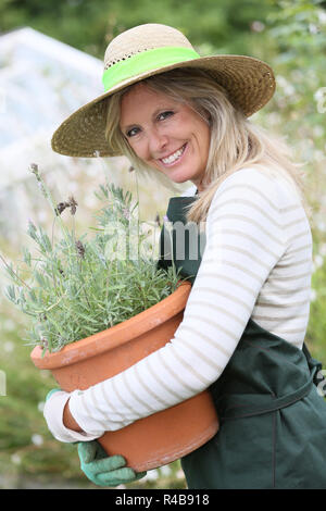 Portrait of beautiful woman gradening aromatic plants Stock Photo