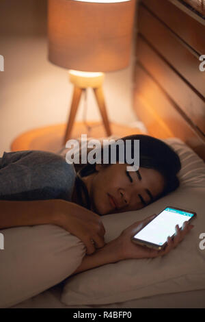 woman fell asleep after using mobile phone Stock Photo