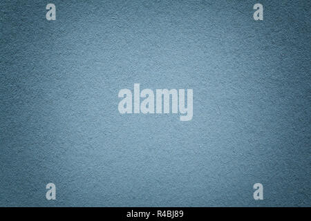 Texture of old gray paper background, closeup. Structure of dense light blue kraft cardboard. Felt gradient steel backdrop closeup. Stock Photo