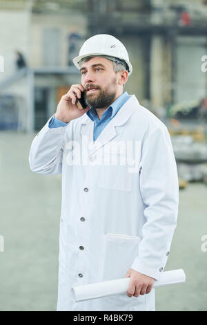 Factory Worker Speaking by Phone Stock Photo