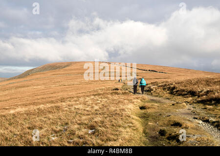 Walkers Heading towards the Summit of High Street From Thornthwaite Crag, Lake District, Cumbria, UK Stock Photo