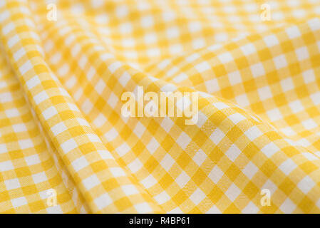 foled white and yellow checkered tablecloth Stock Photo