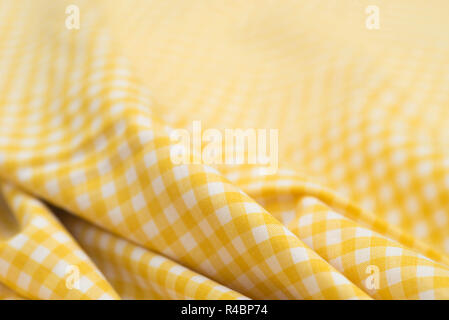 foled white and yellow checkered tablecloth Stock Photo