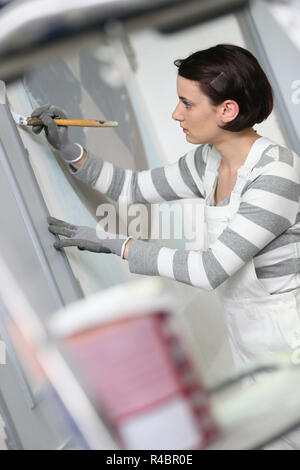 Young woman in professional school to become painter Stock Photo