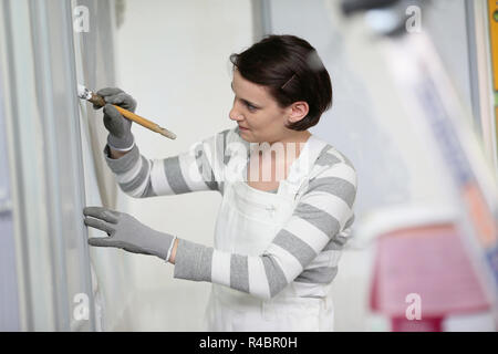 Young woman in professional school to become painter Stock Photo