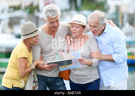 Senior tourists using tablet on visiting journey Stock Photo