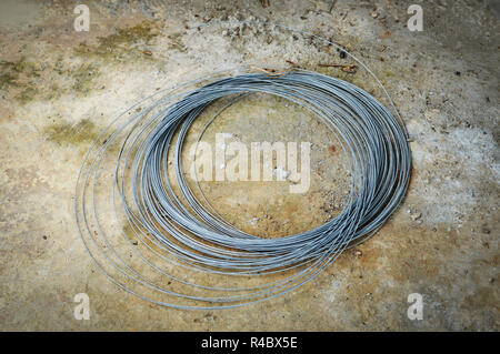 galvanized wires industrial / pile of wire galvanized roll up on ground in the construction site Stock Photo