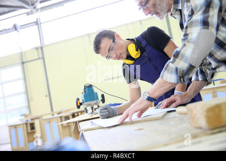 Carpenter with apprentice in training period Stock Photo