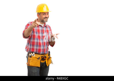 Smiling male constructor pointing at camera with index finger with asking gesture isolated on white background Stock Photo