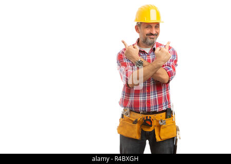 Builder holding arms crossed with middle fingers up with joking expression isolated on white background Stock Photo
