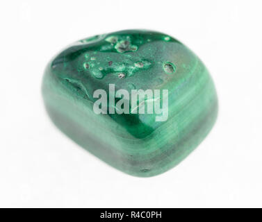 macro photography of natural mineral from geological collection - tumbled malachite stone on white background Stock Photo