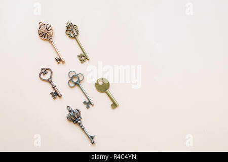 Collection vintage keys isolated. Flat lay. Top view.Antique keys flat lay pattern isolated on pastel background.old keys , small retro key collection, key pattern.Copy space Stock Photo