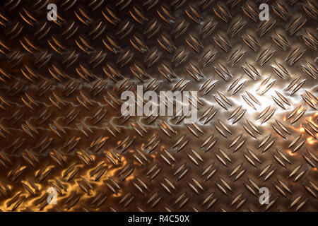 anti-slip texture metal plate, metal plate close up view with colorful light reflections on the surface Stock Photo