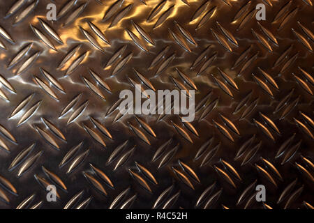 silver diamond steel plate, metal plate close up view with colorful light reflections on the surface Stock Photo