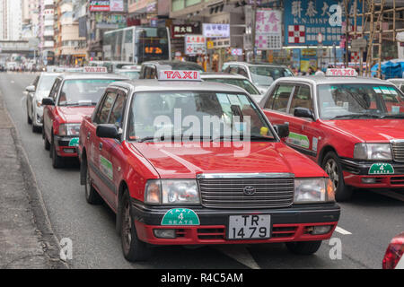 KOWLOON, HONG KONG - APRIL 21, 2017: Red Taxi Cabs at Street in Kowloon, Hong Kong. Stock Photo