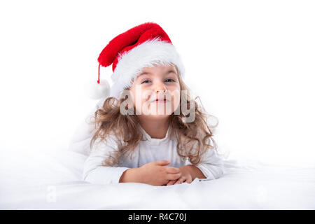 Christmas time, little girl in Santa Claus hat smilling. Stock Photo