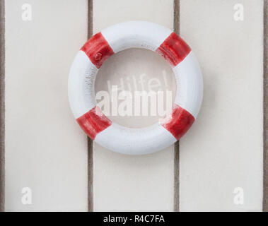 wooden lifebuoy on wood with the word help Stock Photo