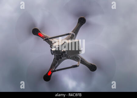 down under the flying drone against grey cloudy sky Stock Photo