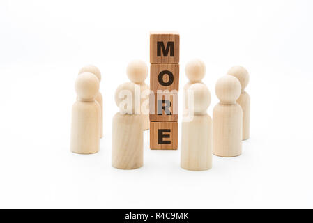Wooden figures as business team in circle around word MORE, isolated on white background, minimalist concept Stock Photo