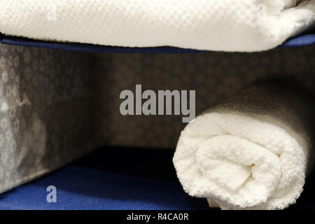 Stacked white spa towels. white towels in rolls Stock Photo
