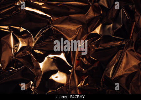 Full frame take of a sheeT of crumpled gold aluminum foil background Stock Photo