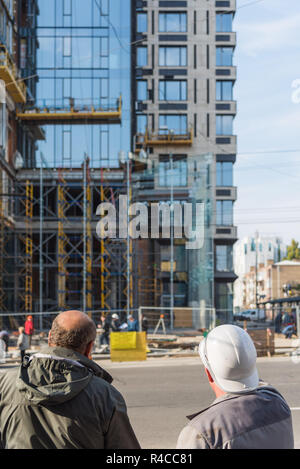 Construction project men in safety helmets - Architect engineer manager at construction site Stock Photo