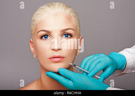 Cosmetic plastic surgeon injecting aesthetics face Stock Photo