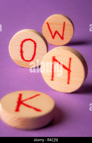 Know word written in red ink on round wood pieces, on a purple background. Knowledge concept. Know now. Stock Photo